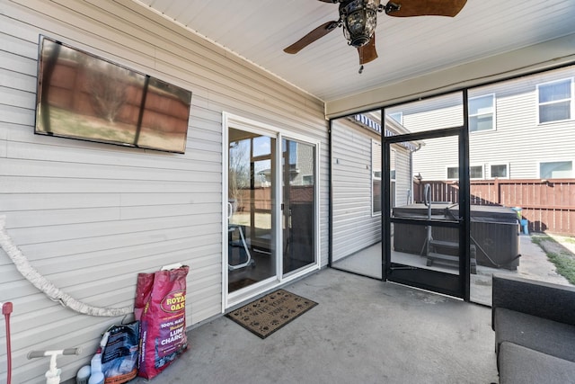 sunroom / solarium featuring a ceiling fan