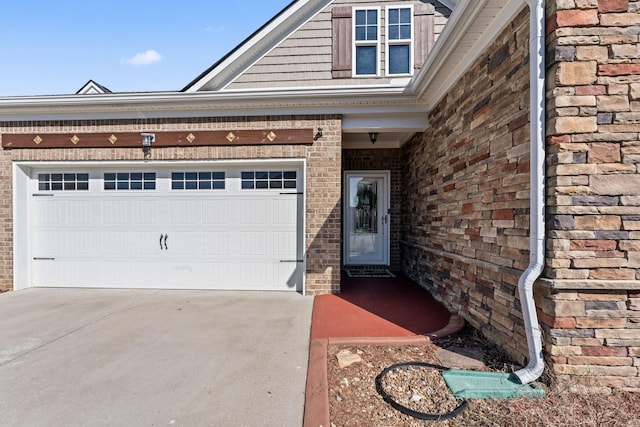 view of front of home featuring a garage, concrete driveway, and brick siding