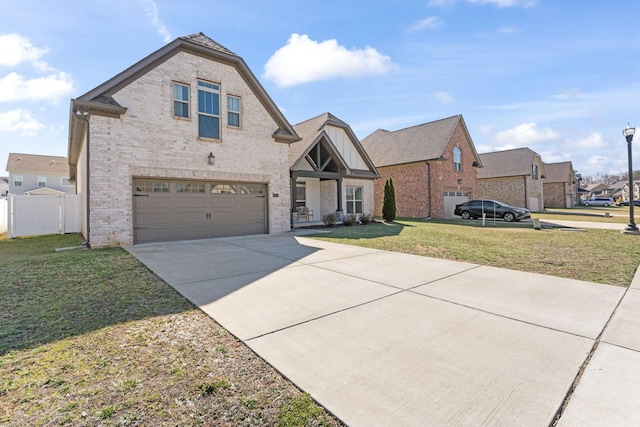 traditional-style house featuring an attached garage, brick siding, fence, concrete driveway, and a front lawn