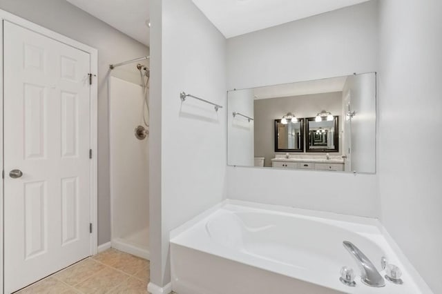 full bath featuring baseboards, tile patterned floors, a garden tub, and a shower stall