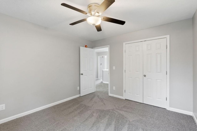 unfurnished bedroom with carpet, baseboards, and a closet