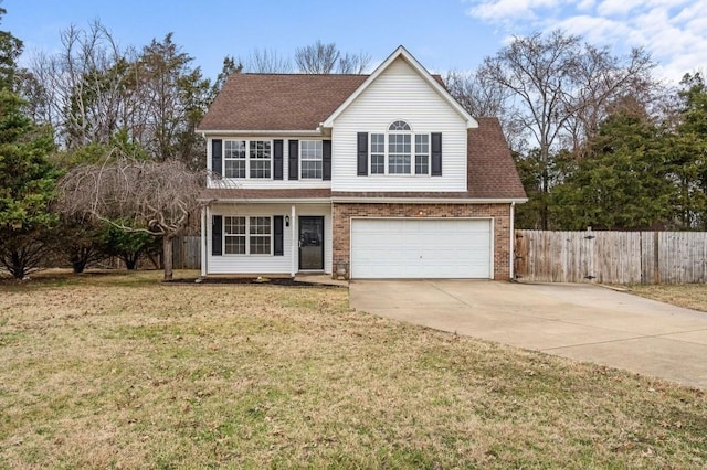 traditional-style home featuring driveway, a front yard, fence, and brick siding