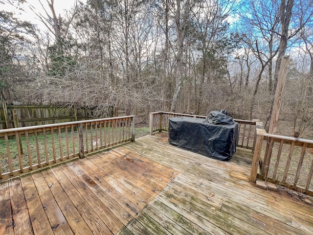 wooden deck featuring fence and area for grilling