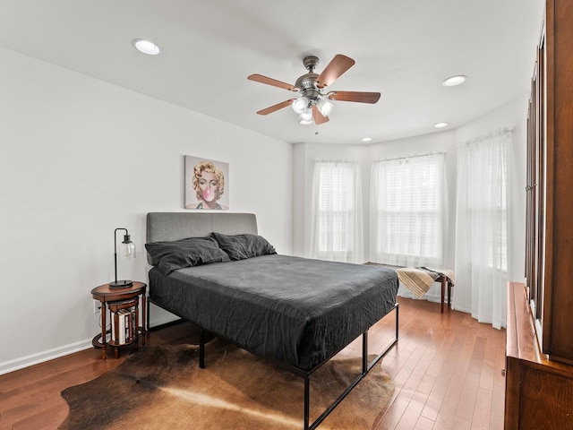 bedroom with ceiling fan, baseboards, wood finished floors, and recessed lighting