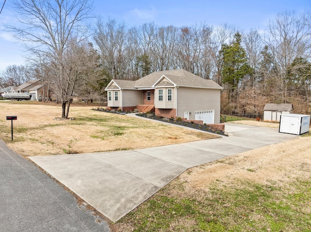 view of front of home with a storage unit, a garage, an outdoor structure, driveway, and a front lawn