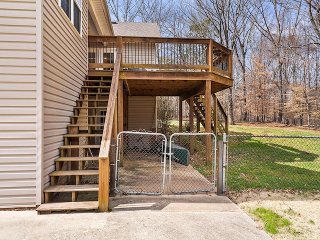 exterior space with a yard, a shingled roof, a gate, fence, and stairs