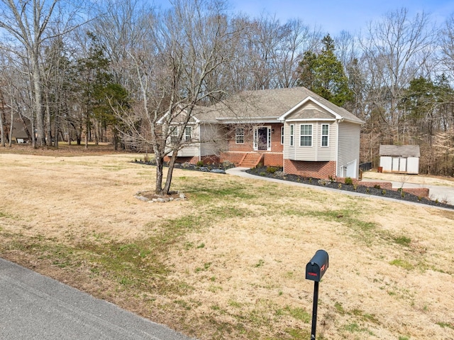 ranch-style house with a storage shed, an attached garage, an outdoor structure, a front lawn, and brick siding