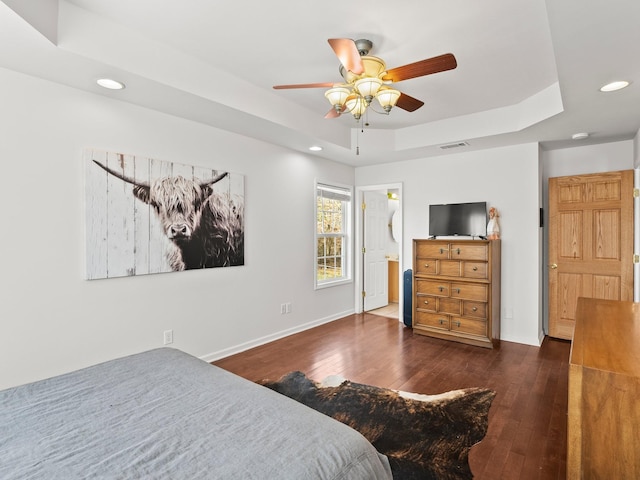 bedroom with recessed lighting, a raised ceiling, visible vents, baseboards, and hardwood / wood-style flooring