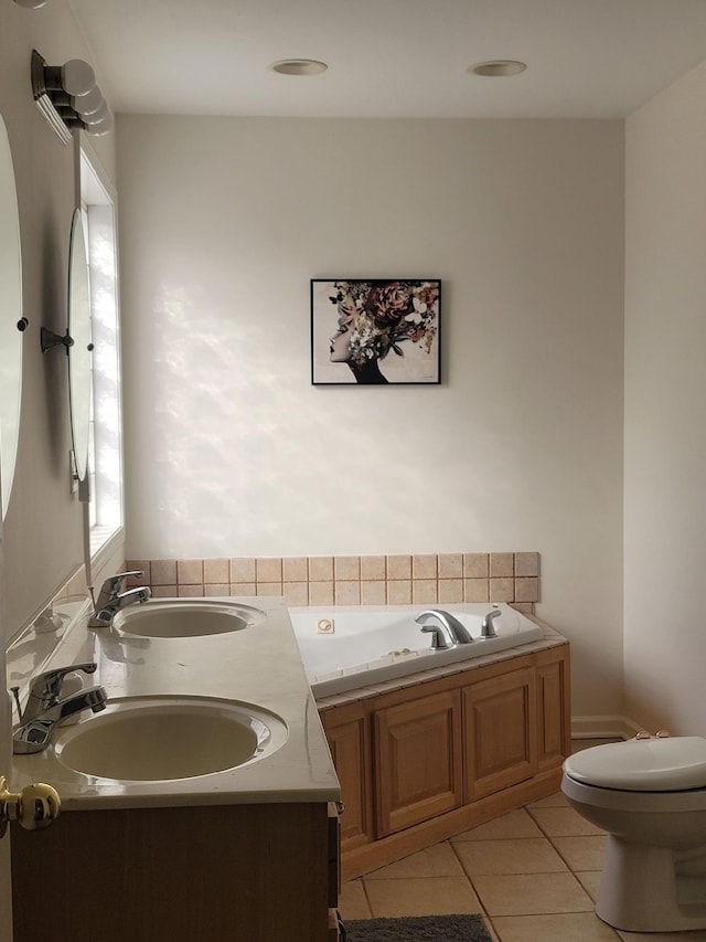 full bathroom with toilet, a garden tub, a sink, and tile patterned floors