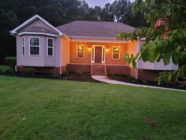 single story home featuring a front lawn and brick siding