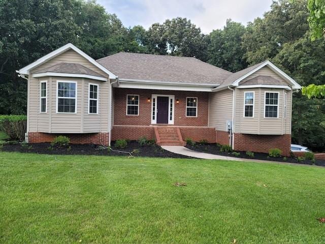 single story home featuring covered porch and a front lawn