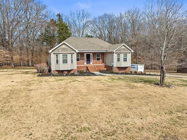 ranch-style house with brick siding, fence, and a front lawn