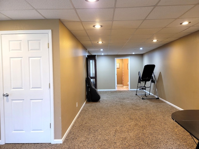 exercise area with a drop ceiling, recessed lighting, carpet flooring, and baseboards