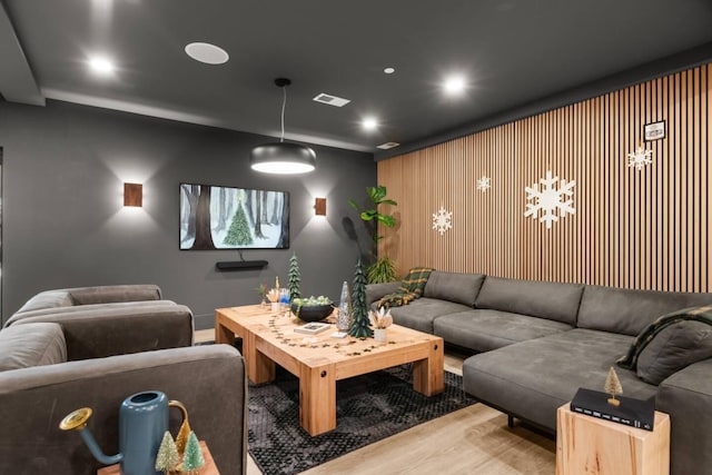 home theater room featuring wood finished floors, visible vents, and recessed lighting