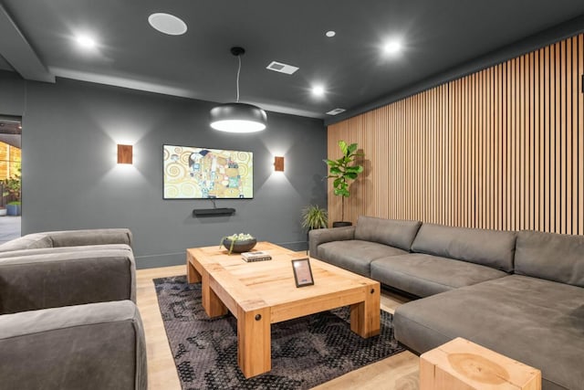 home theater with light wood-style flooring, visible vents, and recessed lighting