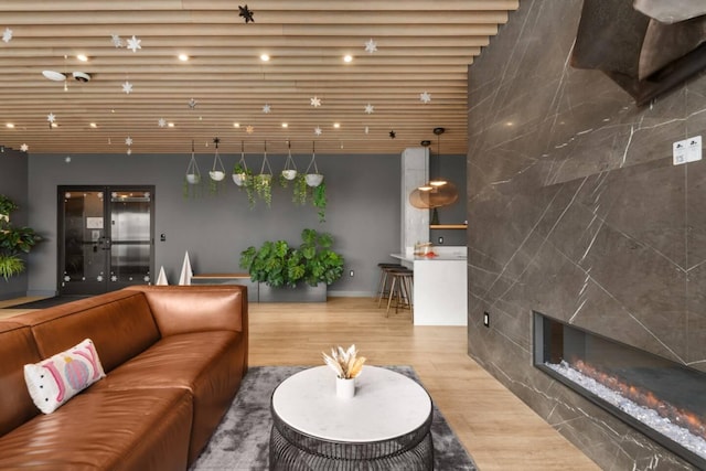 living area featuring a tiled fireplace and wood finished floors