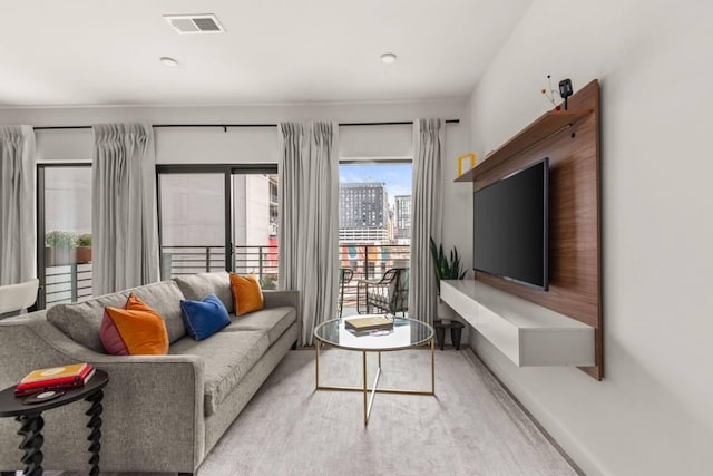 living room with baseboards and visible vents