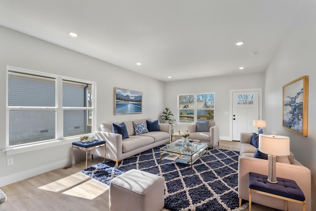 living area featuring baseboards, wood finished floors, and recessed lighting