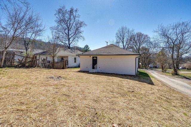 rear view of property with a lawn