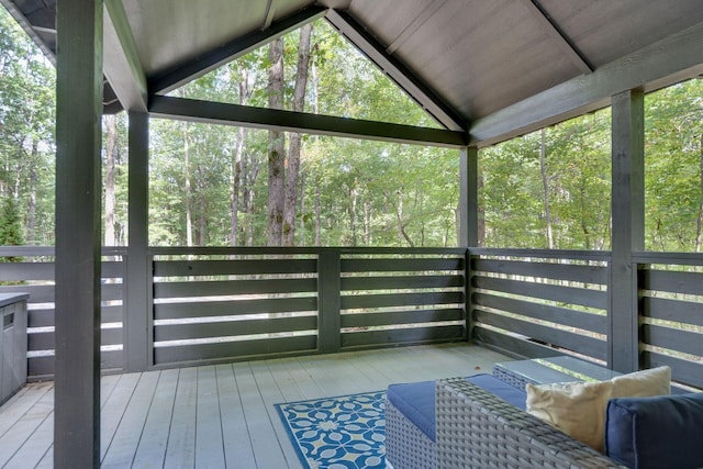 sunroom / solarium featuring lofted ceiling