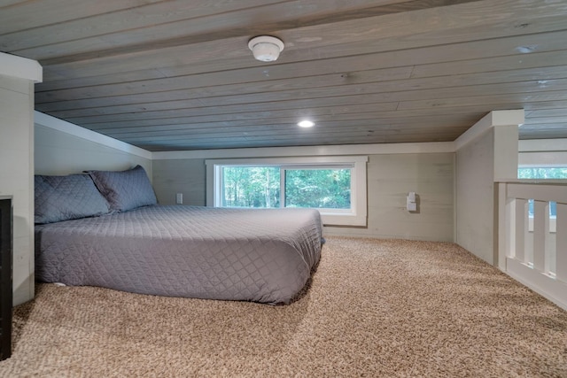 carpeted bedroom with lofted ceiling, wooden ceiling, and multiple windows