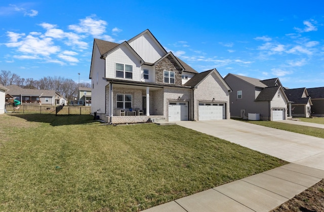 view of front of home featuring covered porch, board and batten siding, a front yard, fence, and driveway