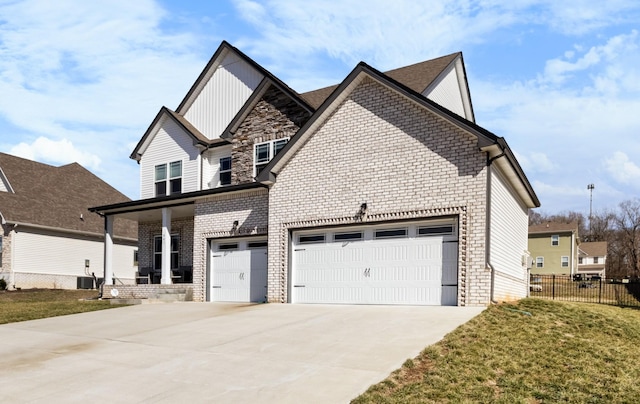 view of front facade featuring an attached garage, brick siding, fence, driveway, and stone siding