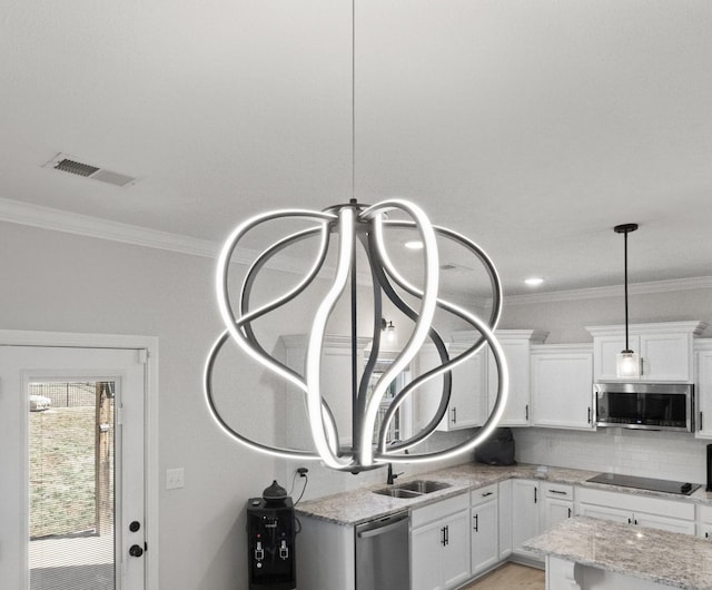 interior details with stainless steel appliances, ornamental molding, visible vents, and decorative backsplash