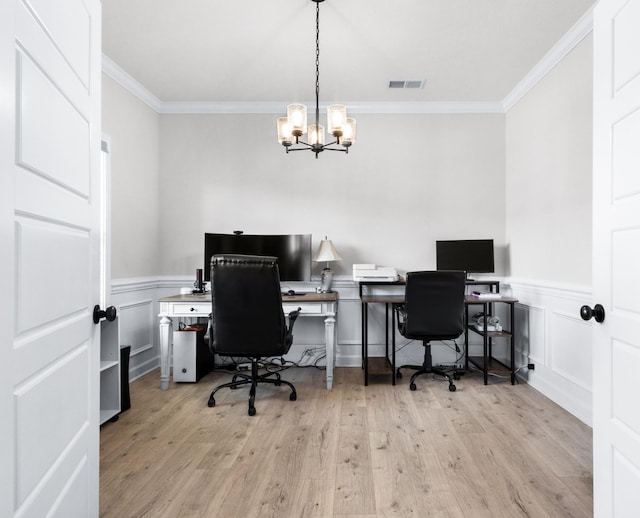 home office with a wainscoted wall, crown molding, visible vents, an inviting chandelier, and light wood-type flooring