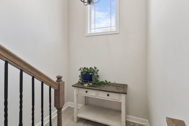 stairway featuring baseboards and wood finished floors