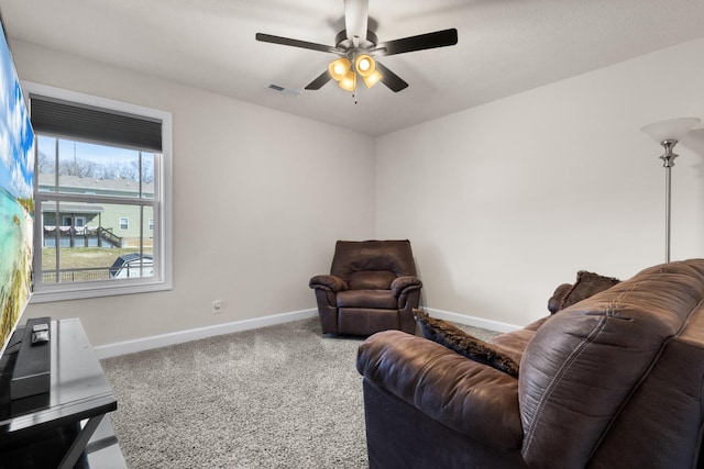 sitting room with a ceiling fan, baseboards, visible vents, and carpet flooring