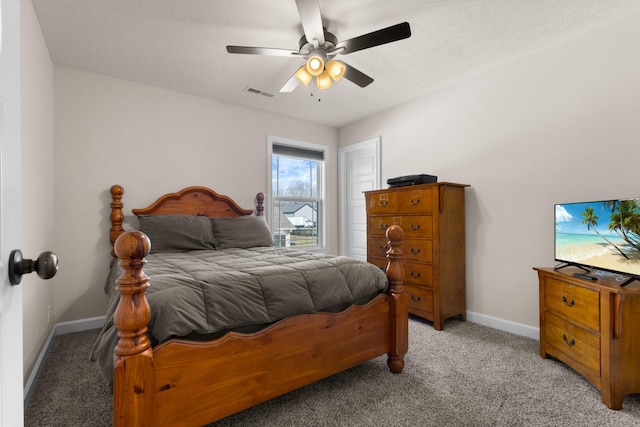 bedroom featuring baseboards, ceiling fan, visible vents, and light colored carpet