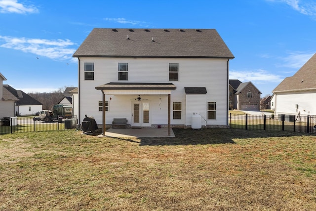 back of house featuring ceiling fan, a fenced backyard, a patio, and a yard