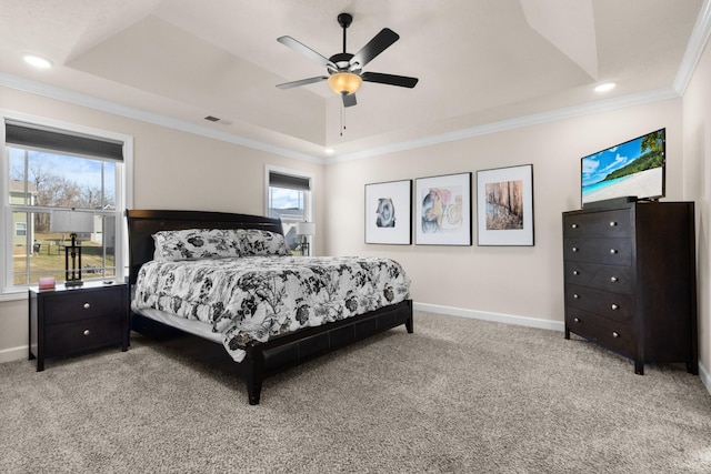 bedroom featuring light carpet, a tray ceiling, and baseboards