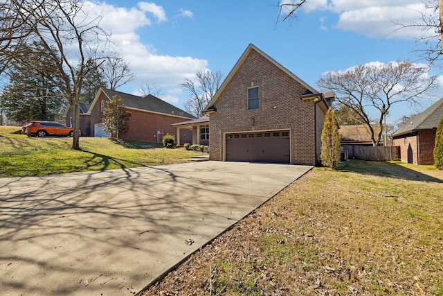 view of side of home with brick siding, a yard, fence, a garage, and driveway