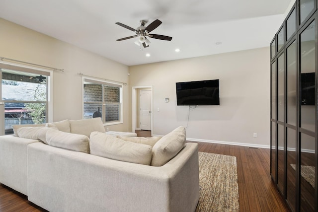 living area featuring dark wood-style floors, ceiling fan, baseboards, and recessed lighting