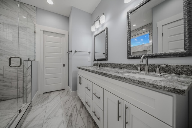 full bath with marble finish floor, double vanity, a sink, and a shower stall