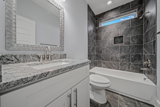 bathroom featuring toilet, washtub / shower combination, and vanity