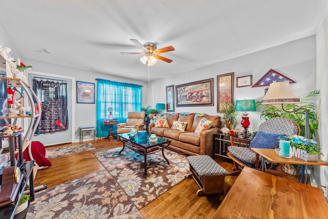 living room with ceiling fan and wood finished floors