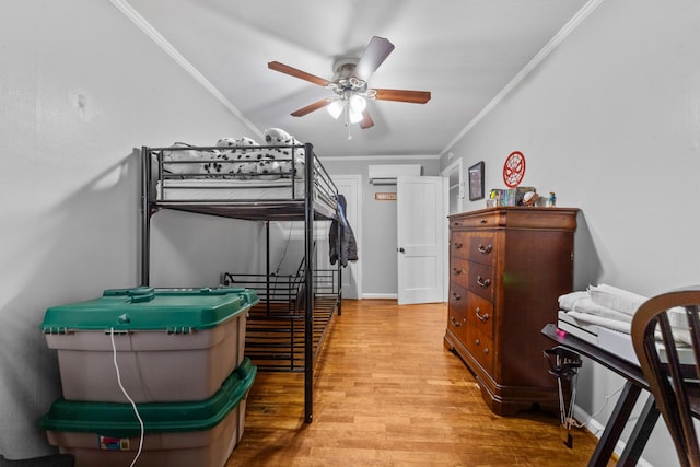 bedroom with a wall mounted AC, a ceiling fan, crown molding, and wood finished floors