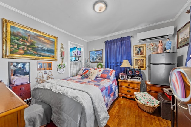 bedroom featuring a wall mounted AC, light wood-type flooring, freestanding refrigerator, and crown molding