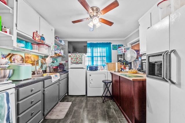 kitchen with white fridge with ice dispenser, a sink, freestanding refrigerator, open shelves, and washer / clothes dryer