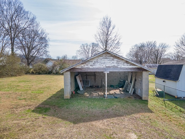 view of pole building with a yard and fence