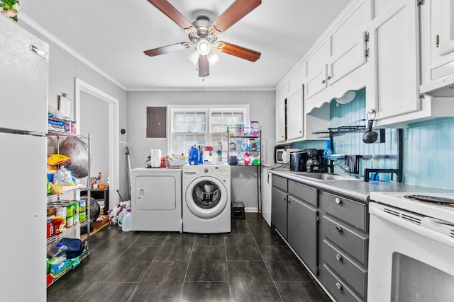 interior space featuring light countertops, white cabinets, a sink, separate washer and dryer, and white appliances