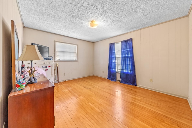 spare room featuring a textured ceiling and wood finished floors