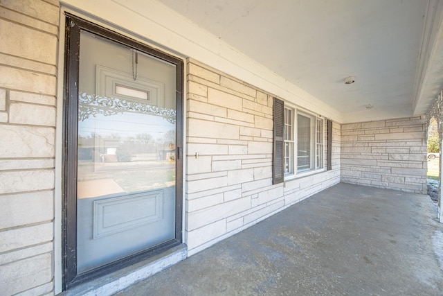 view of exterior entry featuring brick siding