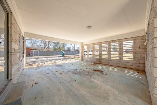 empty room with a healthy amount of sunlight and concrete flooring