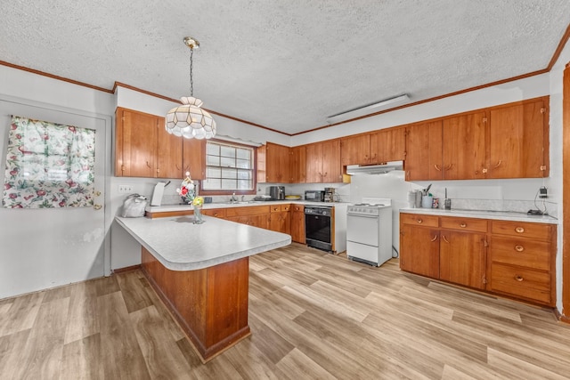 kitchen featuring brown cabinets, gas range gas stove, light countertops, hanging light fixtures, and a peninsula