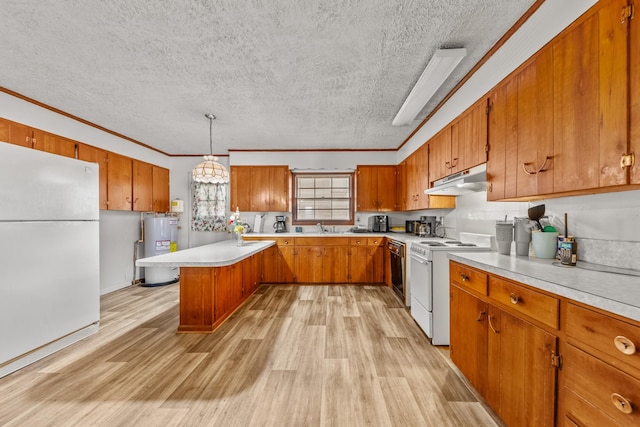 kitchen with light countertops, hanging light fixtures, brown cabinetry, electric water heater, and white appliances