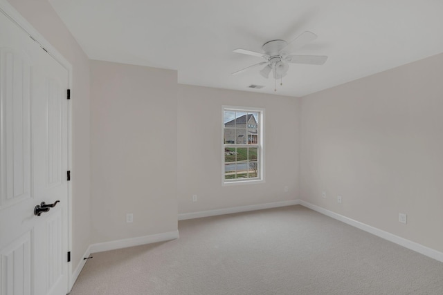 unfurnished bedroom featuring a ceiling fan, light colored carpet, visible vents, and baseboards